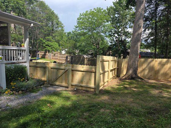 Privacy fence with a framed gate