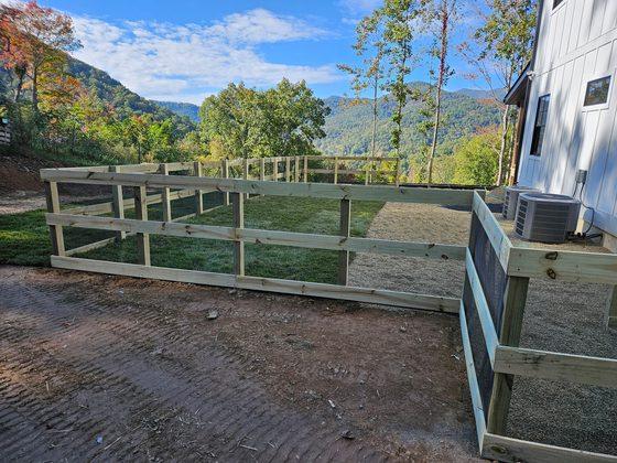 Custom rail fence with wire mesh on a mountain lot