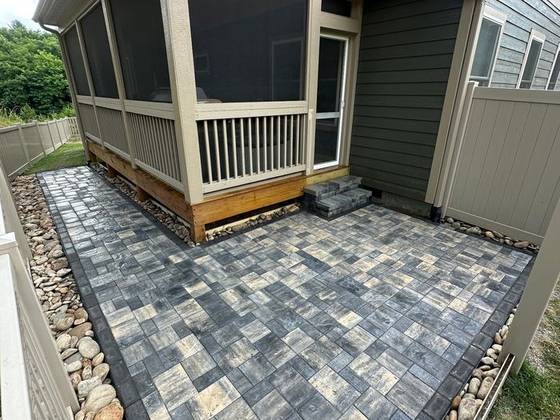 Paver patio wrapping a screened porch