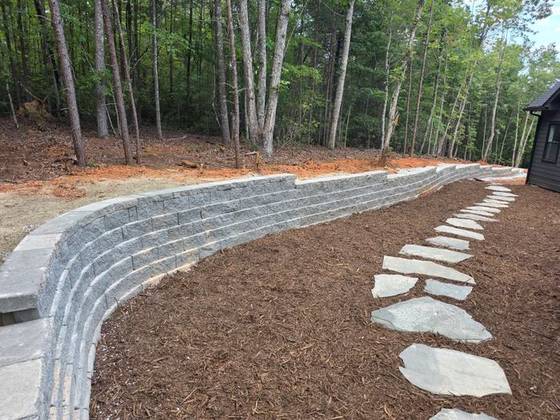 Curved wall with flagstone stepper path